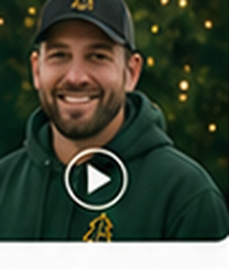 Portrait of a smiling bearded Evergreen Lighting customer in a dark cap and green hoodie.
