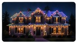 Third nighttime gallery house photograph with multicolored lighting.