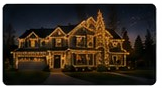 Fourth nighttime gallery house photograph with warm roofline treatment.