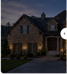 Unlit large stone suburban house at dusk, used as the left half of the before-and-after hero comparison.