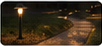 Nighttime garden path with warm bollard lighting.
